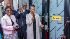 NCBA Group PLC Chief of Staff and Director Strategy, Louisa Wandabwa cuts the ribbon as Group Director, Retail Banking Tirus Mwithiga and Deputy Director, Jane Ng’ang’a look on during the grand opening of the NCBA Ruaka Branch. PHOTO/COURTESY